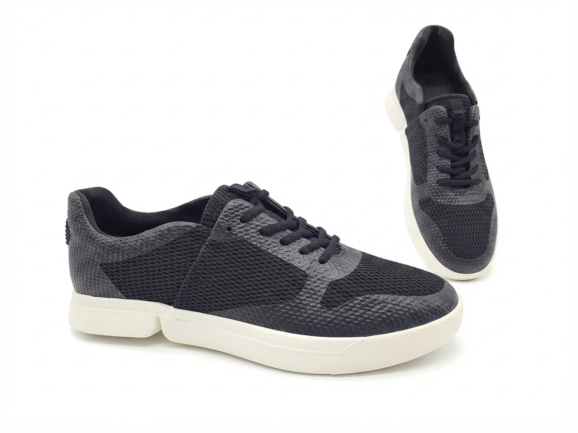 Ein Paar schwarze Sneaker in der Profil- und Draufsicht.